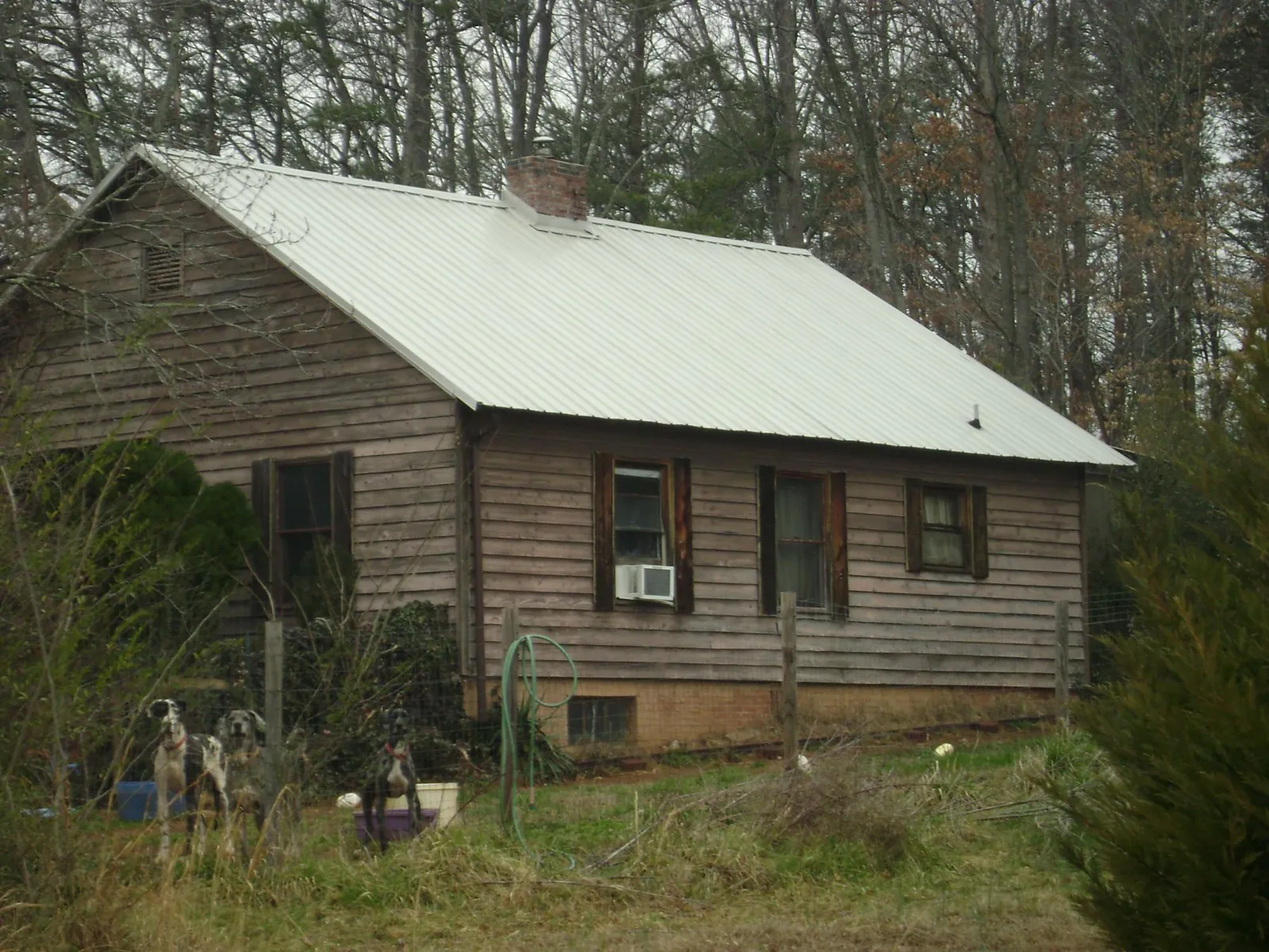 White metal roof on an old wood sided farmhouse, from a Metal Roof Installation job in Wrightsboro